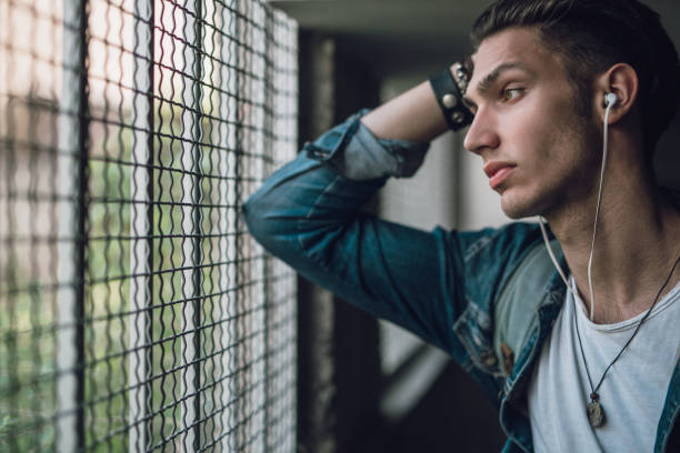 istock Rebel teenager looking through window 956860534