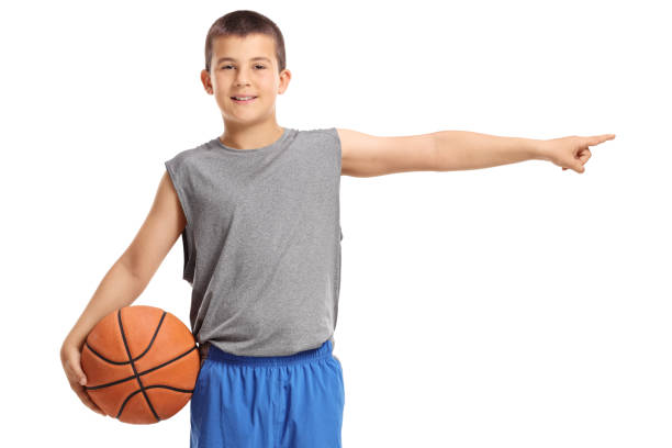 istock Boy holding a basketball and pointing 956860640