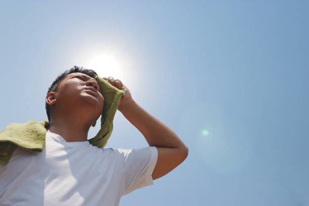 hombre joven y golpe de calor. - temperature fotografías e imágenes de stock