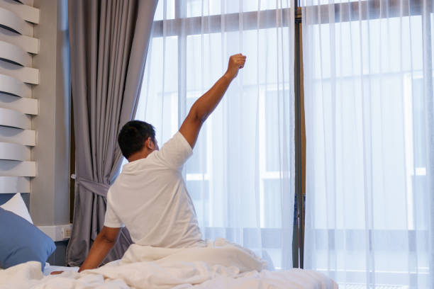 istock Man stretching in bed after wake up in the morning. 956861702