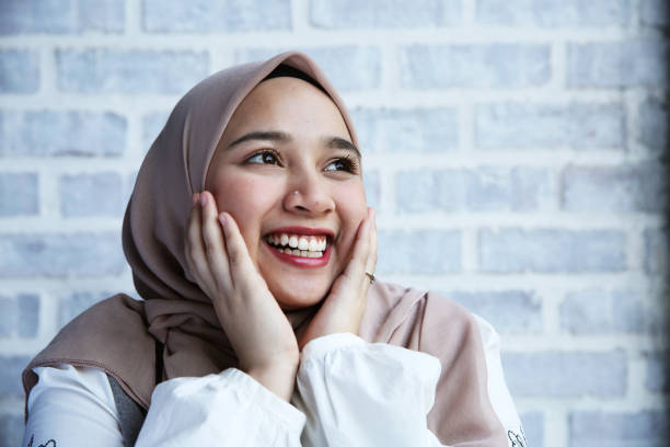 istock A women touch her face and smile with excitement 956864926