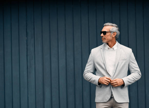 The dapper businessman Cropped shot of a smartly dressed mature businessman standing outside rich man stock pictures, royalty-free photos & images