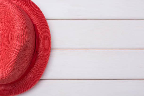 istock red summer hat on white boards, concept fashion 956872966