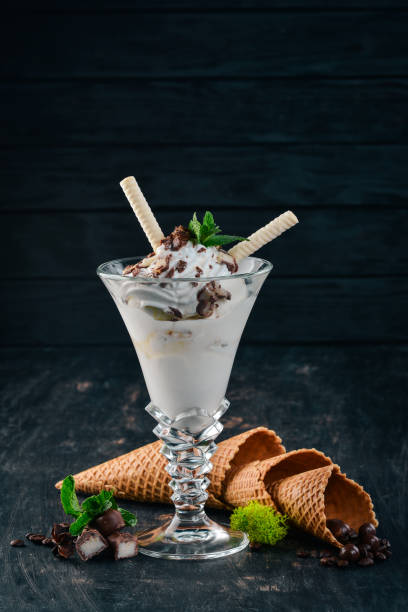 istock Creamy ice cream. On a black wooden background. Copy space. 956873722