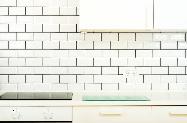 istock White interior design, modern and minimalist style kitchen with household appliances. Open space in living room full of light. Copyspace 956874354