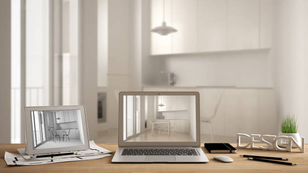 istock Architect designer desktop concept, laptop and tablet on wooden work desk with screen showing interior design project and CAD sketch, blurred draft in the background, modern kitchen idea template 956882856