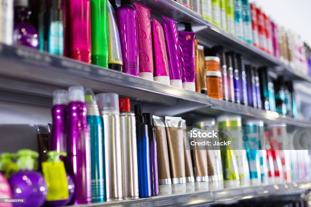 Shelves with hair care products in a cosmetics showroom indoor Shelves with fashionable hair care products in a cosmetics showroom indoor Merchandise Stock Photo