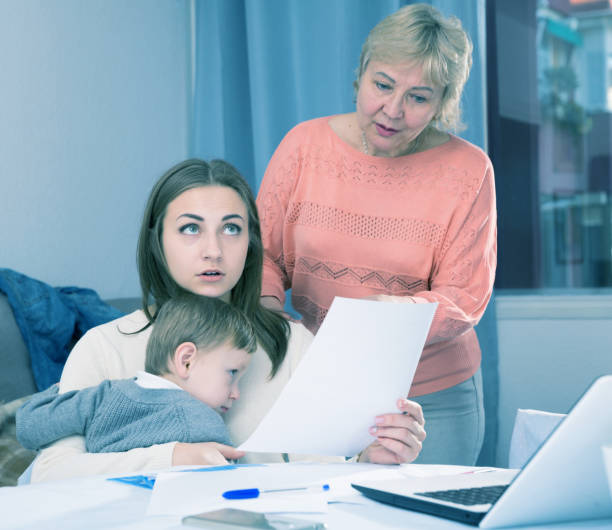 istock Outraged female are having disagreements with her mother for problems with filling documents 956887584