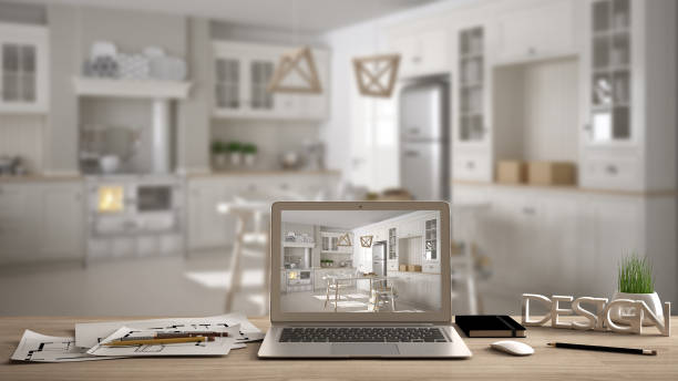 istock Architect designer desktop concept, laptop on wooden work desk with screen showing interior design project, blurred draft in the background, scandinavian kitchen idea template 956887958
