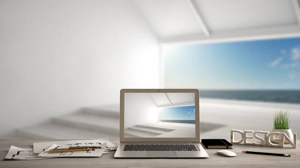 istock Architect designer desktop concept, laptop on wooden work desk with screen showing interior design project, blurred draft in the background, empty panoramic room idea template 956888632