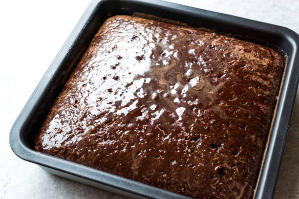 istock Square Juicy Chocolate Sponge Cake with Sauce in Mold. 956891458