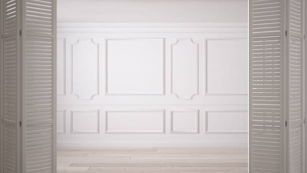 White folding door opening on classic empty space with stucco mouldings and parquet floor, vintage interior design White folding door opening on classic empty space with stucco mouldings and parquet floor, vintage interior design moulding door jamb wood stock pictures, royalty-free photos & images