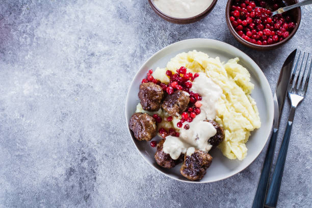 homemade beef and pork meatballs with mashed potatoes and lingonberry sauce on a gray stone concrete background table. lunch dinner food concept. top view, copy space - scandium imagens e fotografias de stock