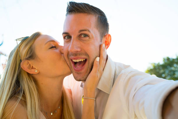 istock portrait cheerful couple taking selfie 956910660