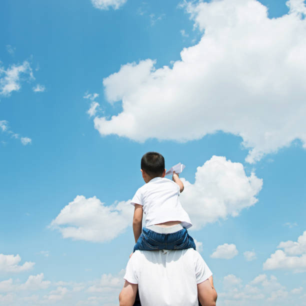 istock Son and father play paper airplane 956915786