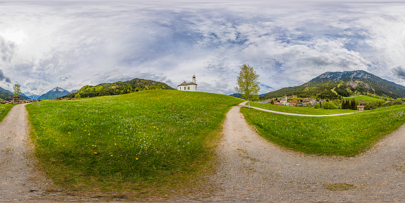 360 degrees spherical panoramic shot of the Alp mountains with a small Sankt Anna church on the hill; Achenkirch, Austria