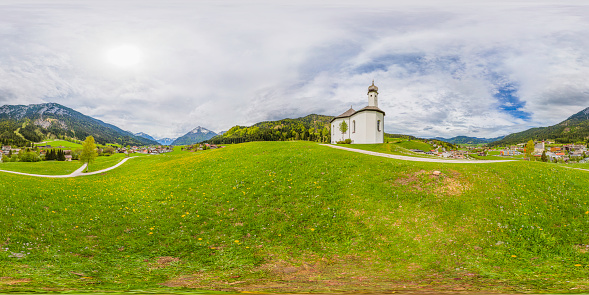 360 degrees spherical panoramic shot of the Alp mountains with a small Sankt Anna church on the hill; Achenkirch, Austria