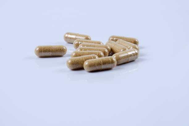 istock Close-Up Of Capsules Over White Background 956916342