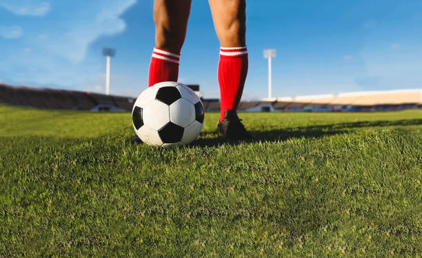 istock Low Section Of Man Playing Soccer At Stadium 956916664