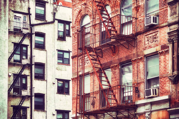 istock Old buildings with fire escapes, NYC. 956917038