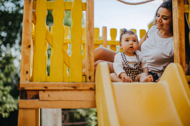 istock Mother and daughter having fun in playground 956917972