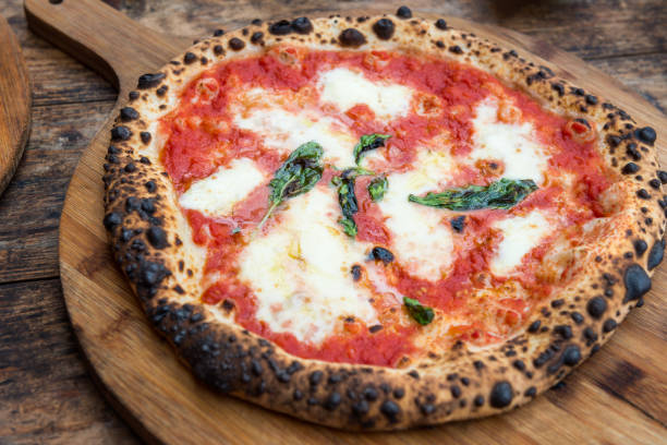 istock Margherita Italian pizza on the thin base with melted mozzarella cheese and tomato 956918598