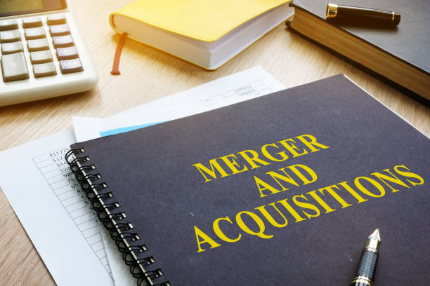 istock Book about Merger And Acquisitions M&A on a desk. 956924704