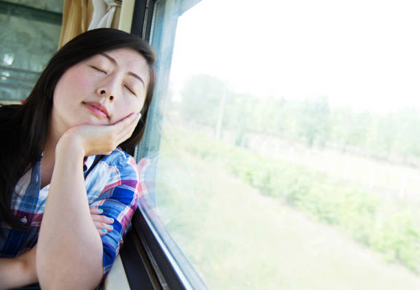 istock Young beautiful woman traveling napping on train 956925534