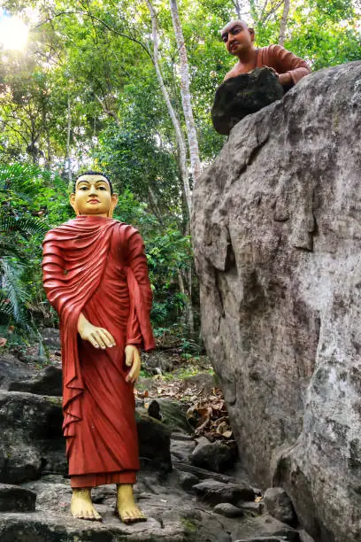 Sculptural composition the demon tries to kill the Buddha with a stone