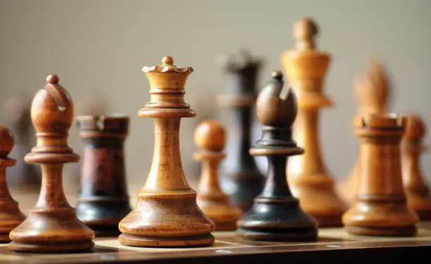 Zoom photograph of chess pieces on a chess board.