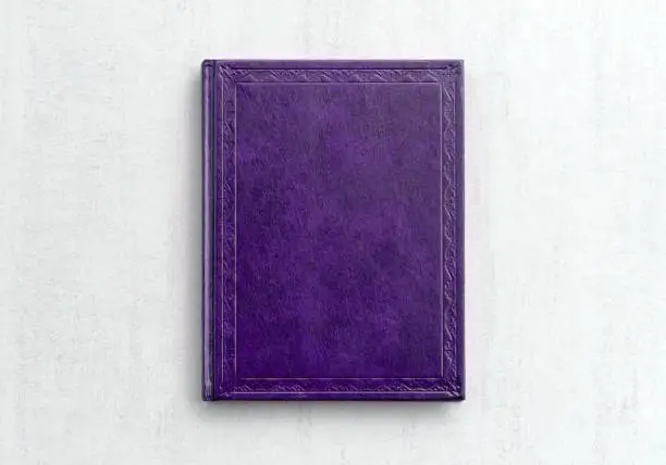 mock up book violet color on gray background close-up, top view