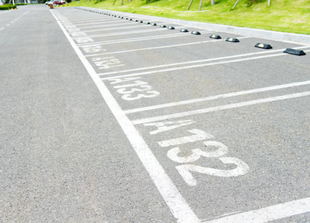 istock Empty car parking lot with white lines 956939154