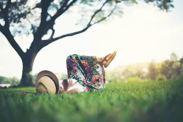 Young woman lying down on grass. relax time.