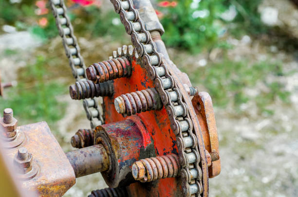istock Parts of old broken machine under corrosion closeup. Old technics. Gears, chains. 956942974