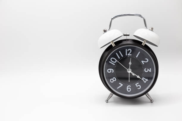 istock Closed up vintage analog clock isolated on white background. 956943782