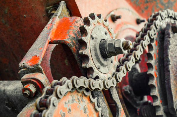 istock Parts of old broken machine under corrosion closeup. Old technics. Gears, chains. 956945502
