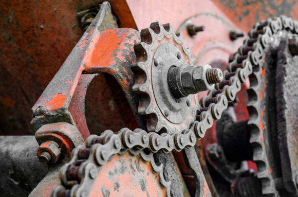 istock Parts of old broken machine under corrosion closeup. Old technics. Gears, chains. 956945518