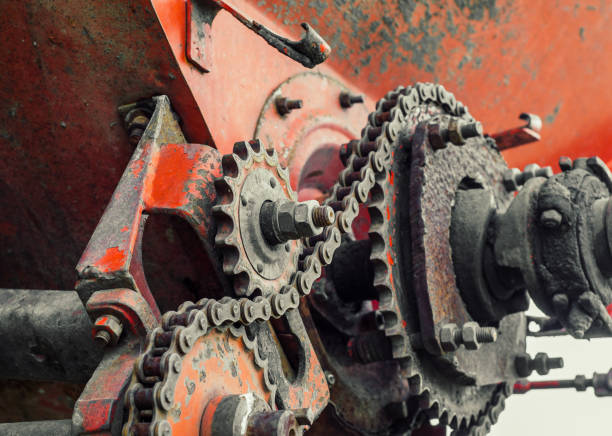 istock Parts of old broken machine under corrosion closeup. Old technics. Gears, chains. 956945544