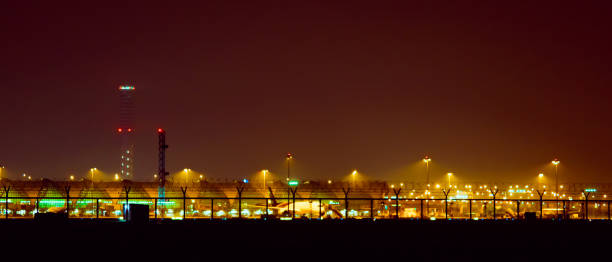 istock night landscape concept from light moving of flight control tower and working activity on ground with night sky background 956946646