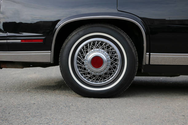 istock chrome wheel with silvery spokes and a new rubber on a black shiny Cadillac 956951154