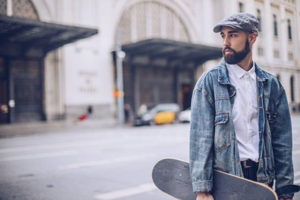 istock Man with skateboard on the street 956958488