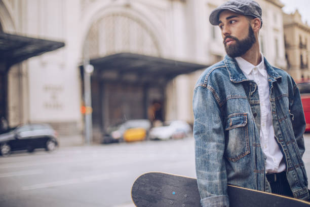 istock Young man with skateboard on the street 956959452