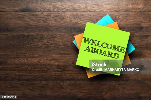 Welcome Aboard The Phrase Is Written On Multicolored Stickers On A Brown Wooden Background Business Concept Strategy Plan Planning Stock Photo - Download Image Now