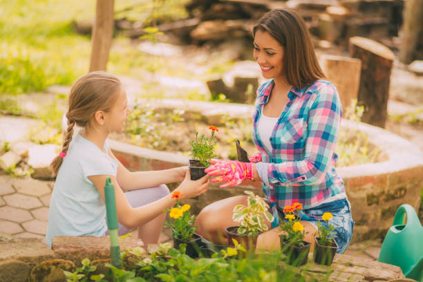 istock Mother And Daughter In Garden 956963536