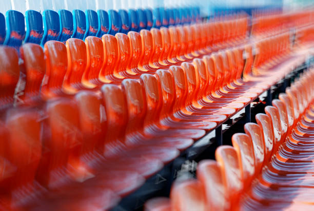 istock Empty red and blue stadium seats in perspective background 956963934