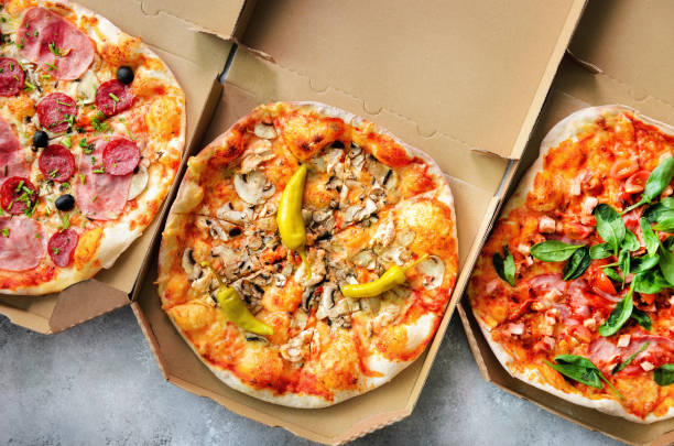 istock Fresh pizza in delivery box on grey concrete background. Top view, copy space 956967644