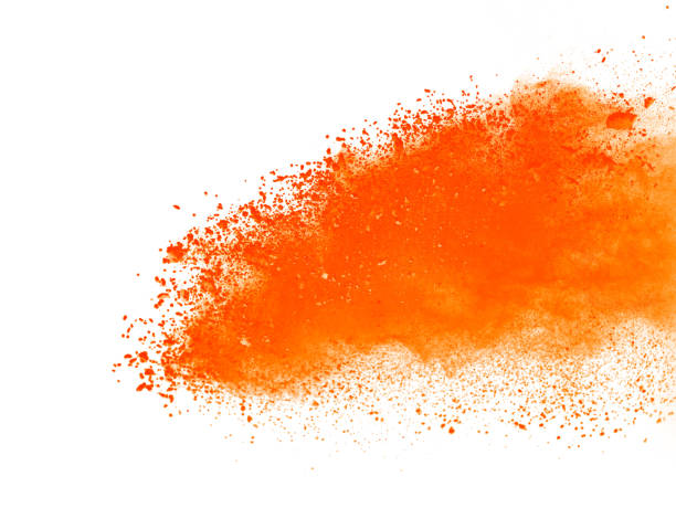 istock Explosion of orange powder on white background 956968410