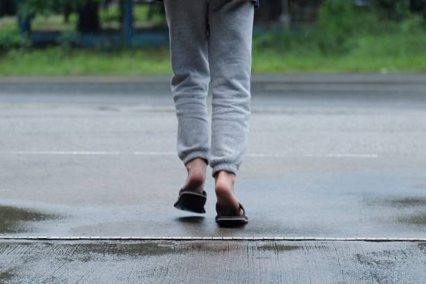 istock boy running on wet street after rain 956969380