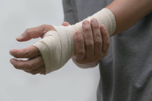 istock Close-up bandaged wrist men's pain his hand after work. 956973260