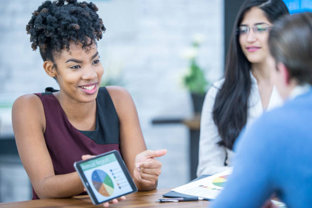 istock Businesswoman showing graphs and laughing 956973864